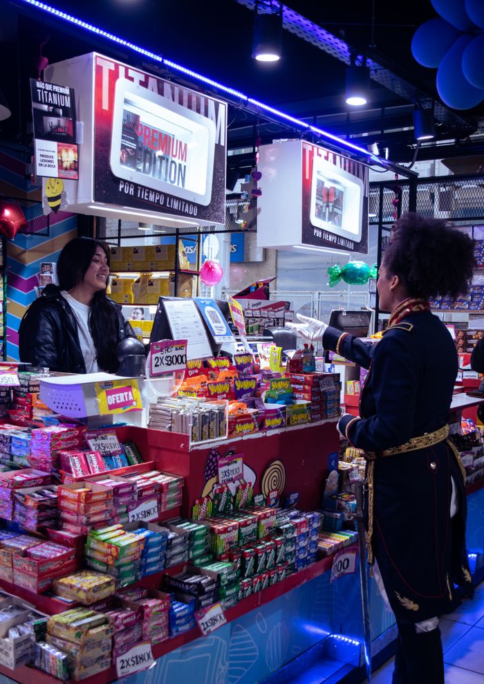 A vibrant candy shop interaction at a market in Buenos Aires, Argentina.